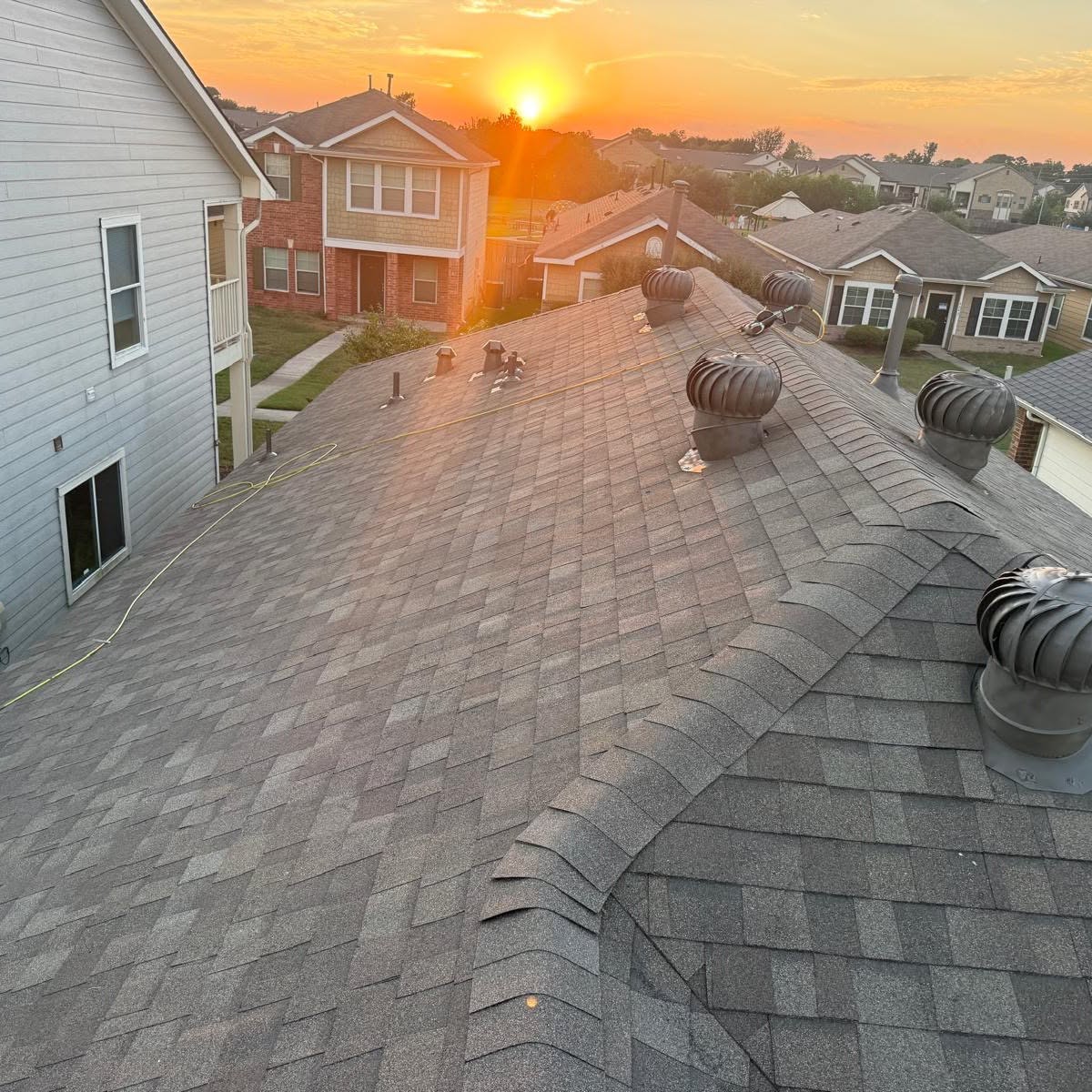 Beautiful finished roof replacement at sunset by EliKay Roofing