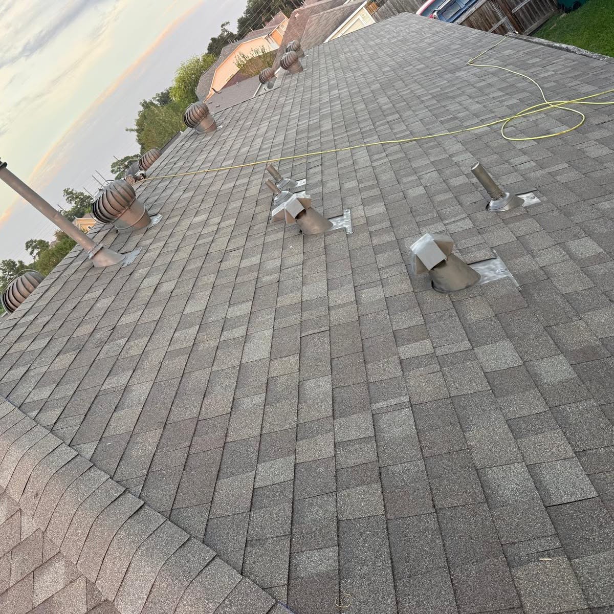 EliKay Roofing craftsman finishing shingles on residential roof